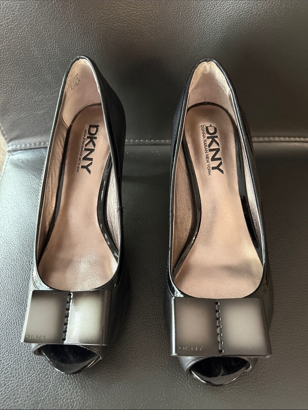 DKNY Peep-Toe Pumps - A Metallic Silver Finish And A Decorative Bow Detail